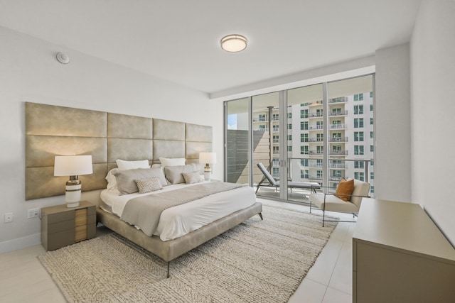 bedroom featuring access to exterior and a wall of windows