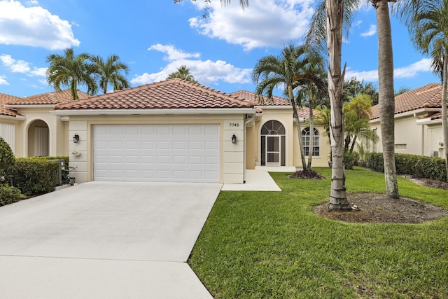 mediterranean / spanish house with a garage and a front yard