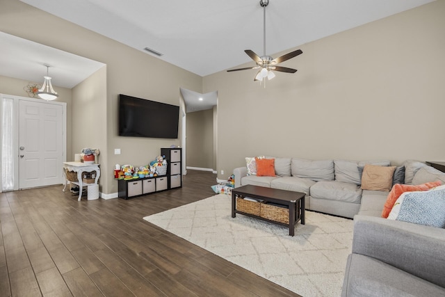 living room with dark hardwood / wood-style floors and ceiling fan