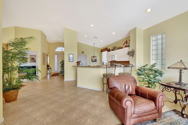 living room with vaulted ceiling and light tile patterned flooring