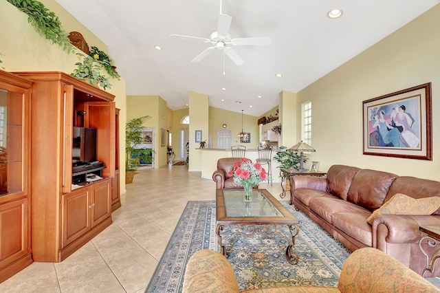 tiled living room with ceiling fan and vaulted ceiling