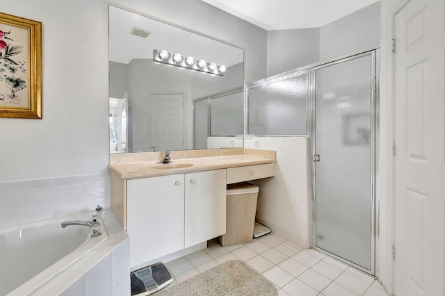 bathroom with tile patterned flooring, vanity, and shower with separate bathtub