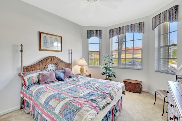 bedroom featuring light colored carpet and ceiling fan