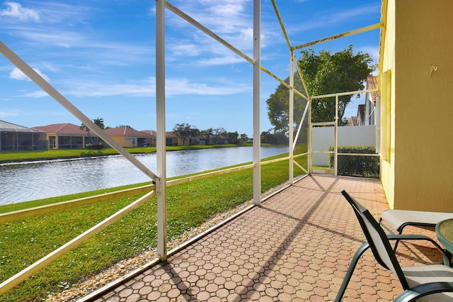 unfurnished sunroom with a water view