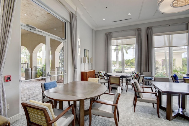 dining room with a wealth of natural light and crown molding