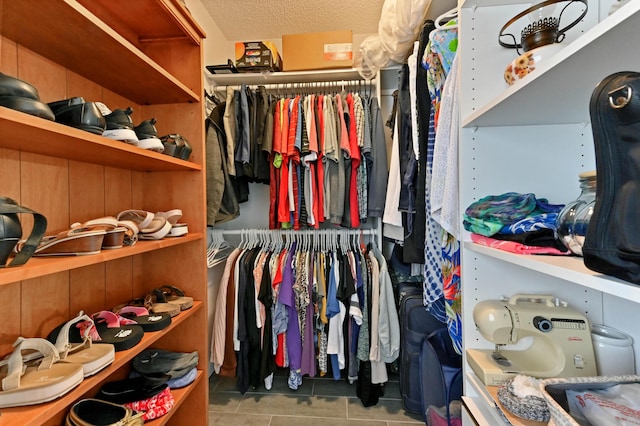 spacious closet with light tile patterned floors