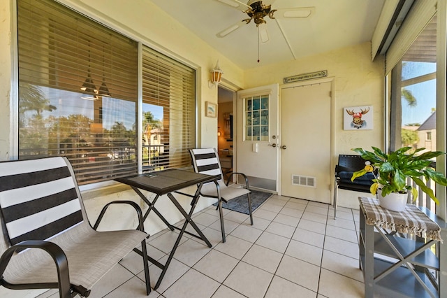 sunroom with a wealth of natural light and ceiling fan