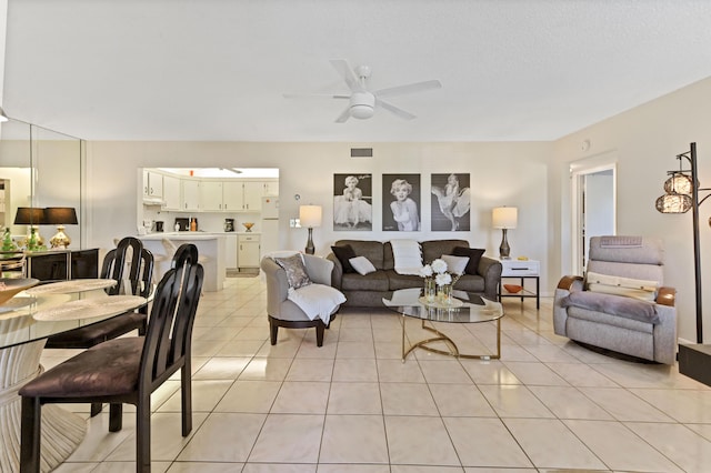 tiled living room featuring a textured ceiling and ceiling fan