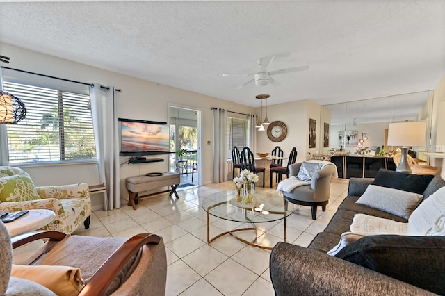 tiled living room with a textured ceiling and ceiling fan