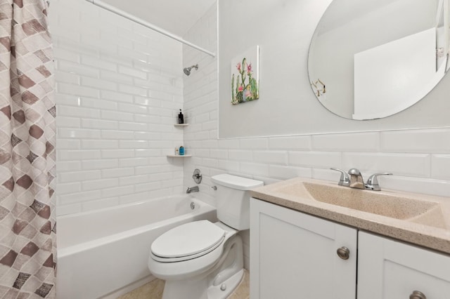 full bath featuring toilet, a wainscoted wall, vanity, tile walls, and shower / tub combo with curtain