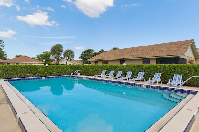 community pool featuring a patio area and fence