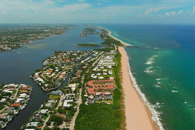 drone / aerial view featuring a water view and a beach view