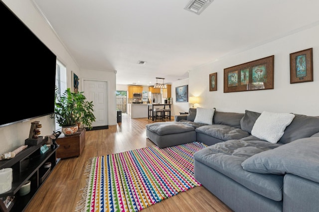 living area featuring wood finished floors and visible vents