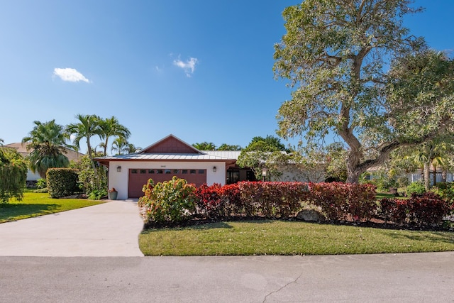 ranch-style house with a garage and a front lawn