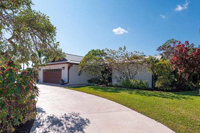 view of front of property with a front lawn and a garage