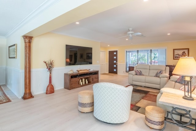 living room with crown molding, decorative columns, ceiling fan, and light hardwood / wood-style flooring