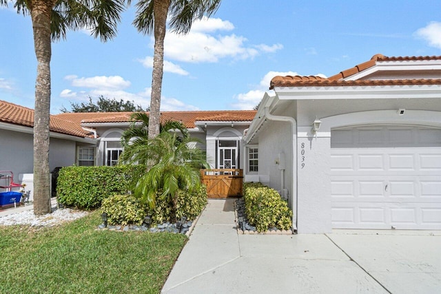 mediterranean / spanish house featuring a garage