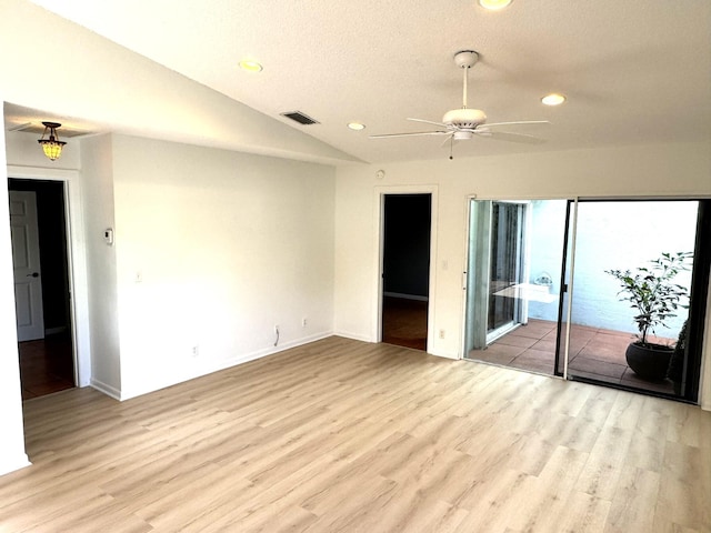 unfurnished room featuring lofted ceiling, ceiling fan, and light hardwood / wood-style floors