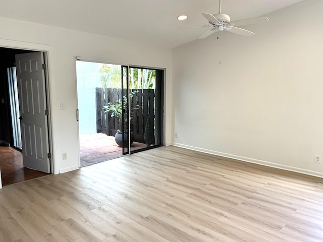 spare room with ceiling fan and light hardwood / wood-style floors