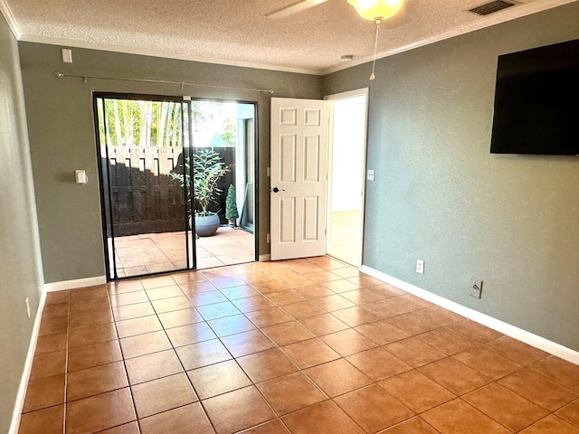 tiled spare room featuring a textured ceiling, ceiling fan, and ornamental molding