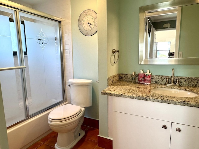 full bathroom with toilet, tile patterned flooring, enclosed tub / shower combo, and vanity