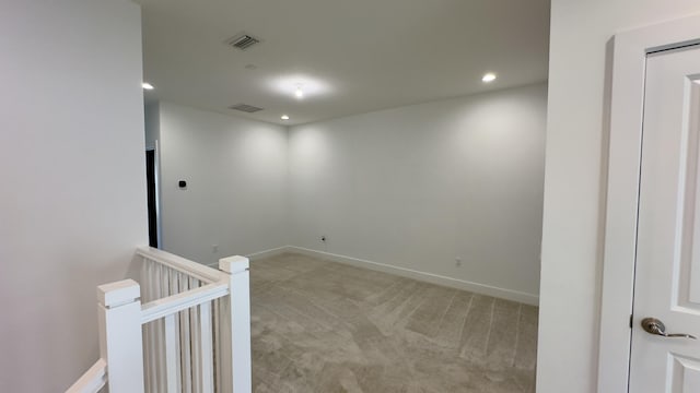 spare room featuring light colored carpet