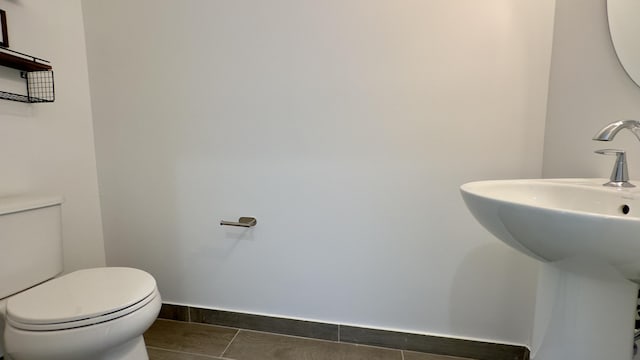 bathroom featuring sink, tile patterned floors, and toilet