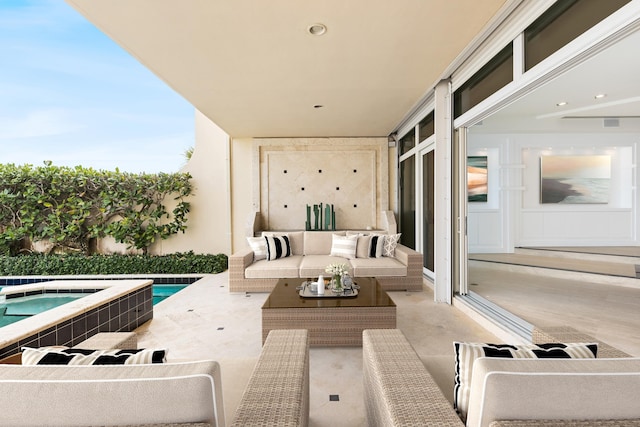 balcony with a patio area, an outdoor hangout area, and a hot tub