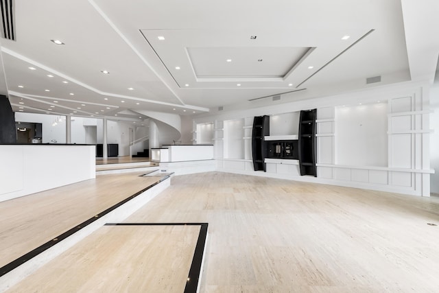 unfurnished living room featuring a tray ceiling