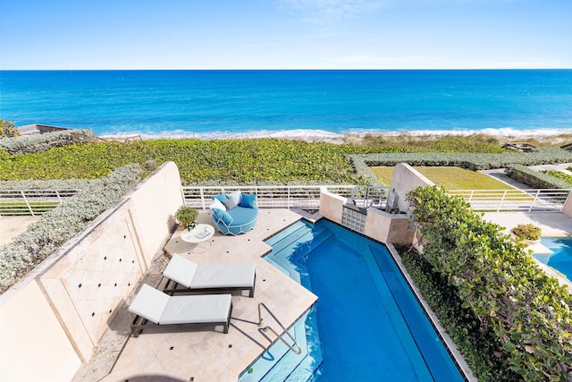 view of pool featuring a view of the beach and a water view