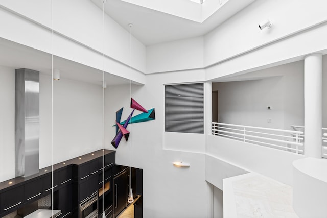 bathroom featuring a towering ceiling and a tub to relax in