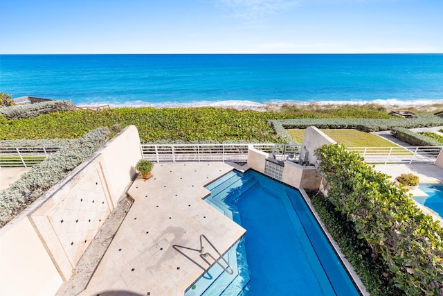 view of swimming pool featuring a beach view and a water view