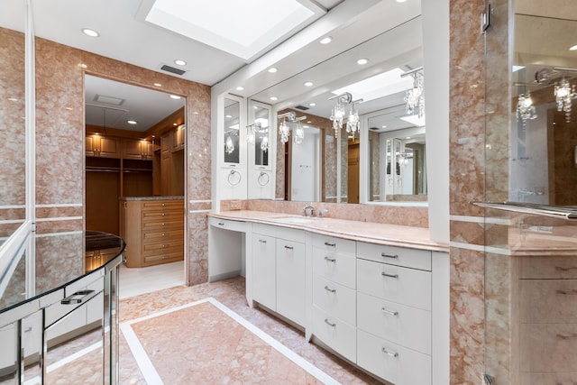 bathroom featuring vanity and a skylight