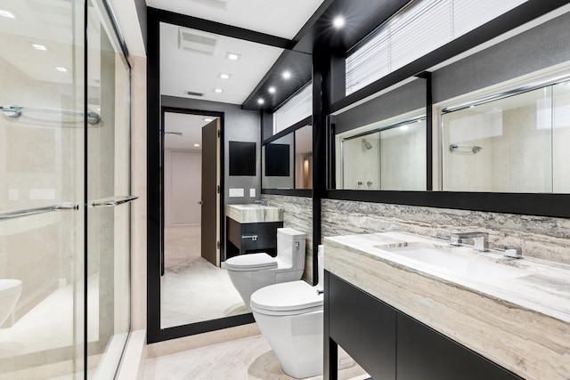 bathroom featuring vanity, toilet, and a shower with door