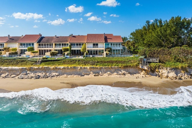 rear view of house with a beach view and a water view