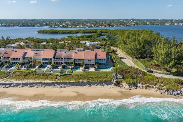 drone / aerial view featuring a water view and a beach view