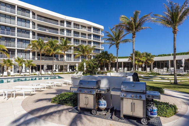 view of swimming pool with a patio area and grilling area