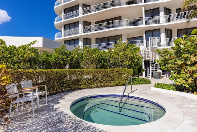 view of pool with a community hot tub and a patio