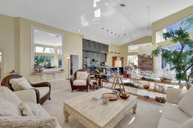 living room with lofted ceiling and a notable chandelier