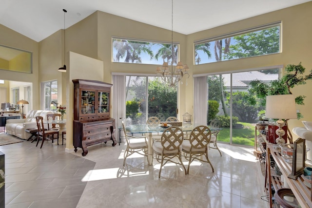 dining room featuring an inviting chandelier and high vaulted ceiling