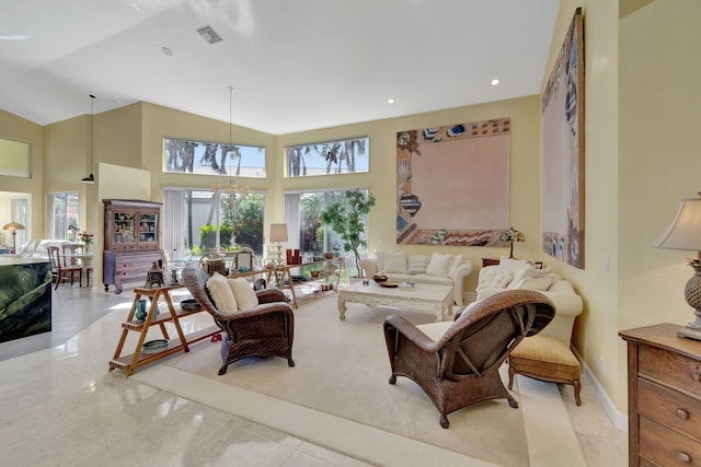 living area with baseboards, visible vents, marble finish floor, high vaulted ceiling, and recessed lighting