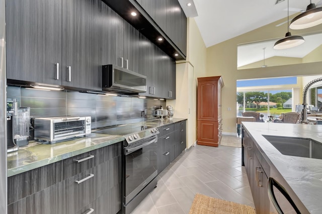 kitchen with lofted ceiling, tasteful backsplash, hanging light fixtures, stainless steel appliances, and light stone countertops