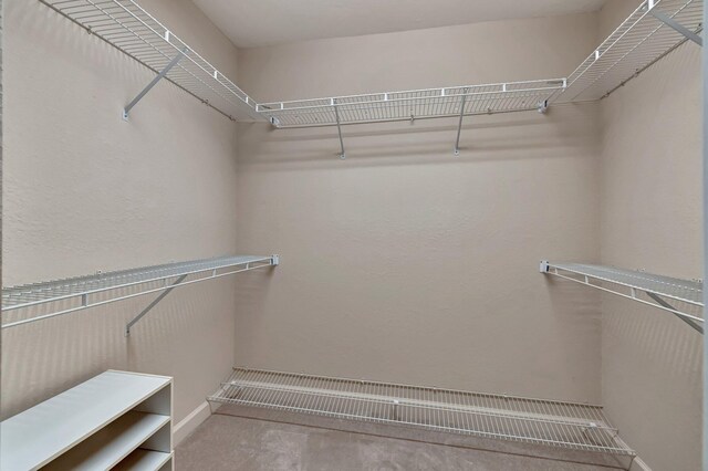 bathroom featuring a closet, vaulted ceiling, a sink, a shower stall, and a bath