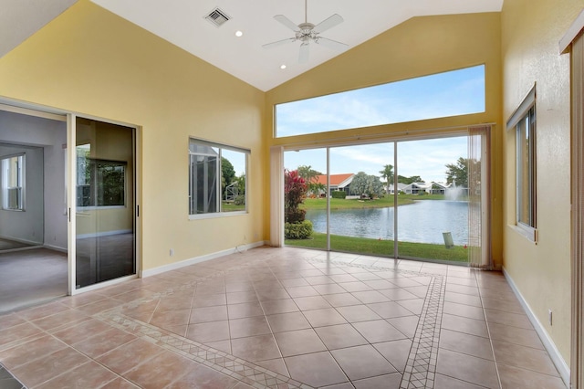 interior space featuring a water view, visible vents, baseboards, and light tile patterned floors