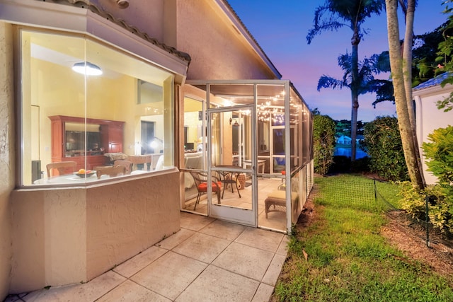 patio terrace at dusk with a sunroom