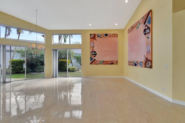 empty room featuring a notable chandelier, high vaulted ceiling, recessed lighting, and baseboards