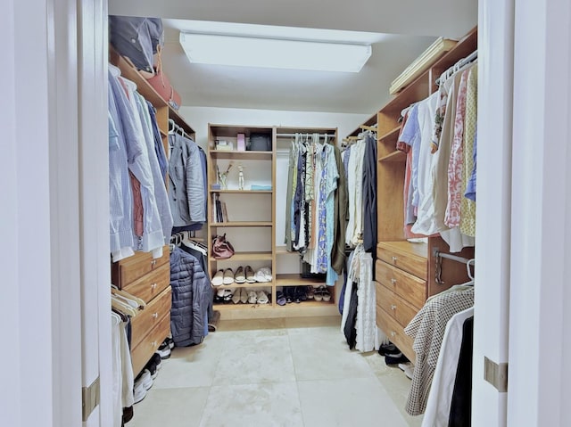 spacious closet featuring light tile patterned floors