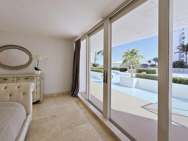 bedroom with access to exterior, french doors, and a wall of windows