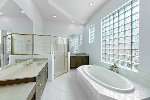 bathroom with tile patterned floors, vanity, and plus walk in shower