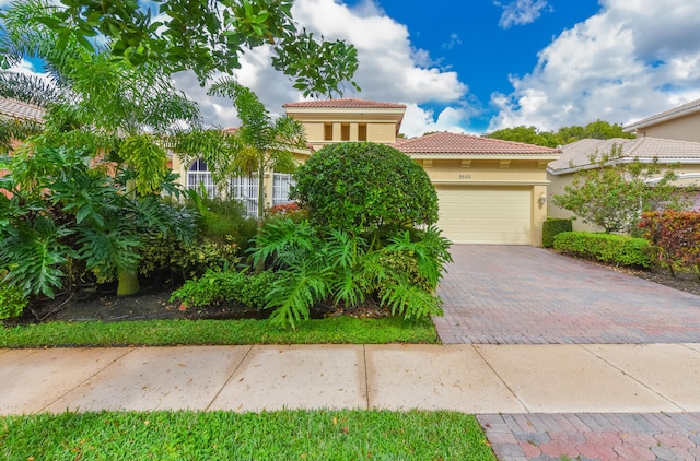 mediterranean / spanish-style home featuring a garage